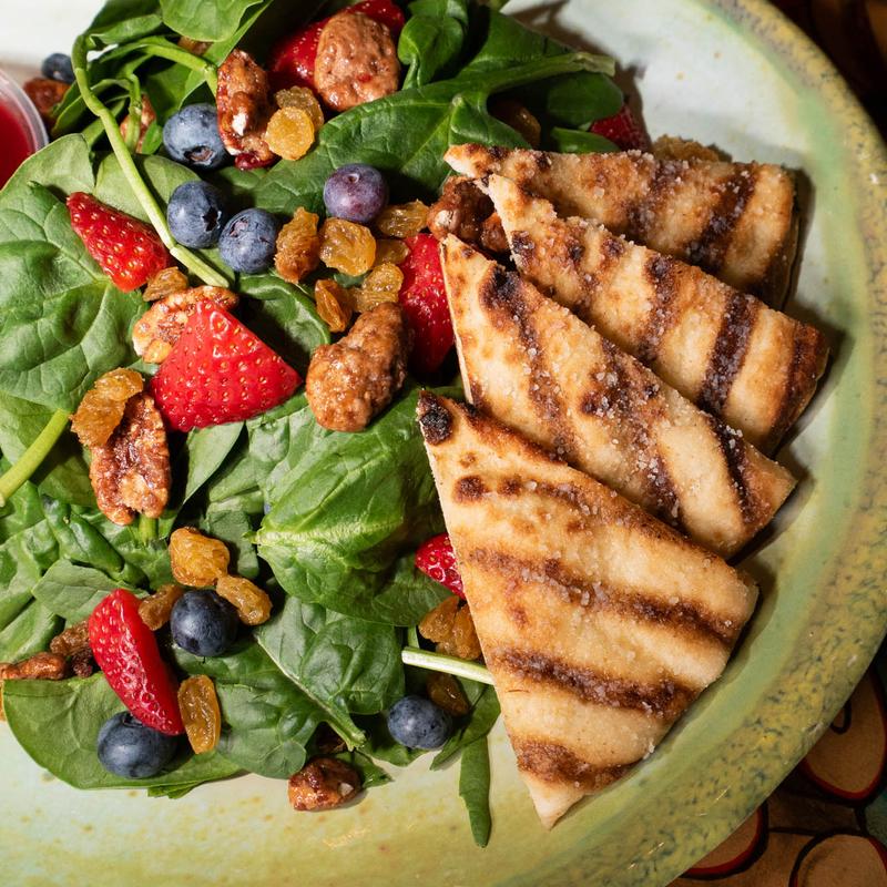 Secret Garden Spinach Salad with berries and candied pecans, side Parmesan flatbread.